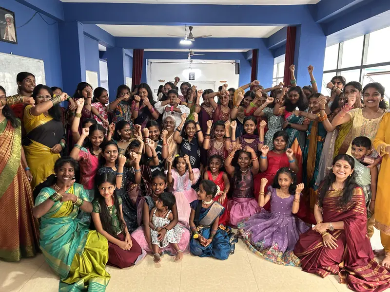 STC students and teachers in festival clothes, celebrating together in the classroom