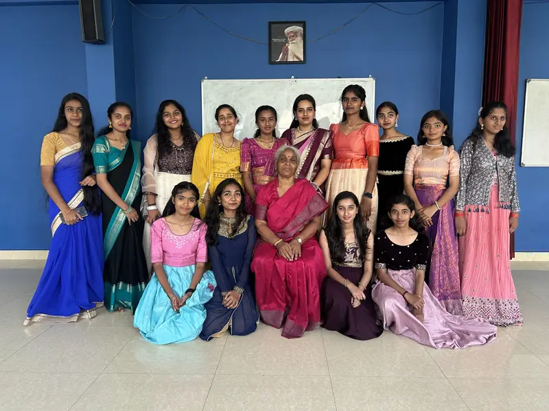 STC students in traditional dress with their teachers in an STC classroom