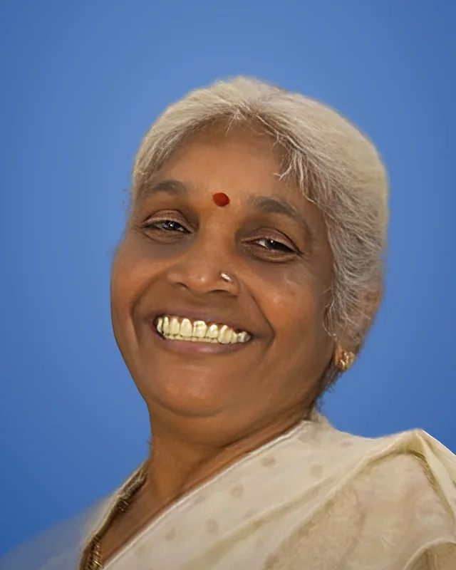 Sujatha R Shetty, founder of STC, smiling, in a cream saree